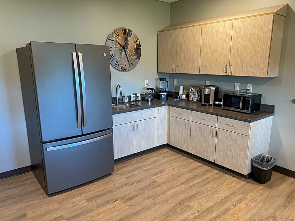 Beacon house cancer Lounger. Area with a counter and fridge.